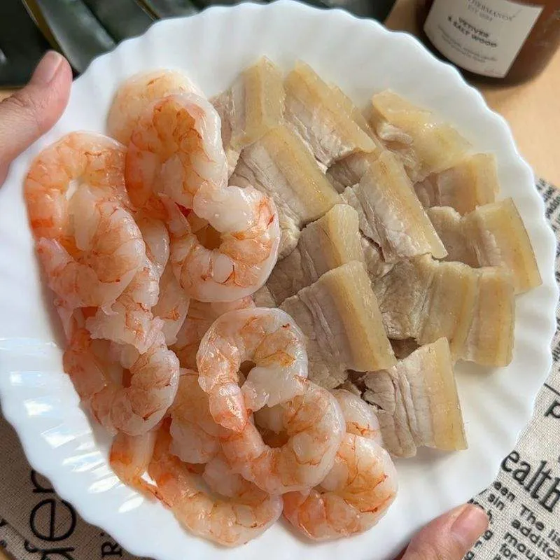 Vietnamese Spring Rolls with Peanut Sauce | Gỏi Cuốn "Boiled pork and prawns, essential ingredients for making delicious and healthy Vietnamese prawn and pork summer rolls, a popular dish filled with fresh herbs and vegetables."