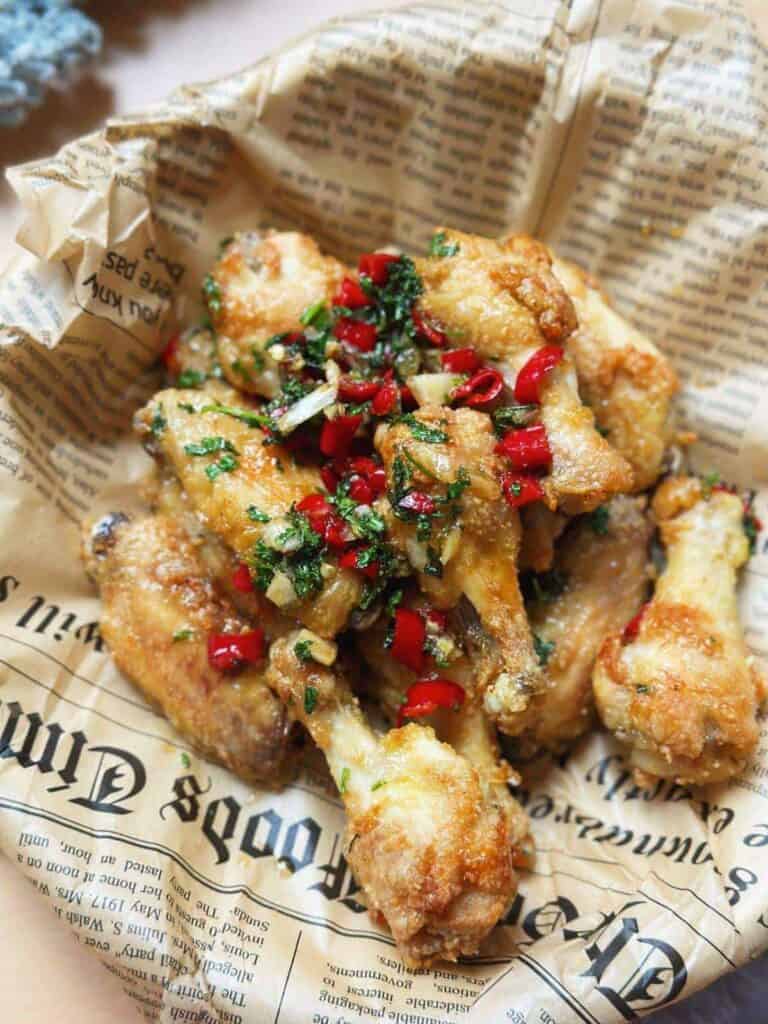 Vietnamese fish sauce chicken wings, cooked in an air fryer. Crispy, golden-brown wings with a glossy sauce. Vibrant colors, enticing aroma, and delightful flavors.
