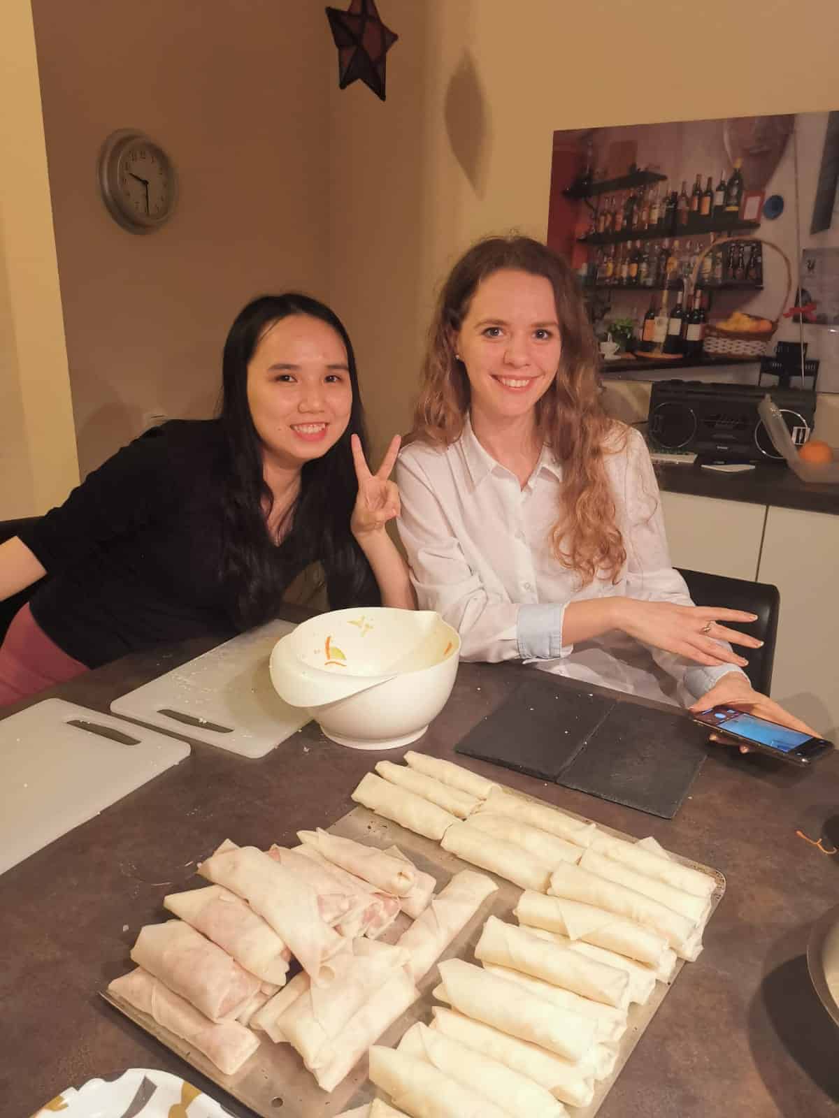 Über mich A joyful moment captured in a photo as Cielle and friends coming together to make spring rolls.
