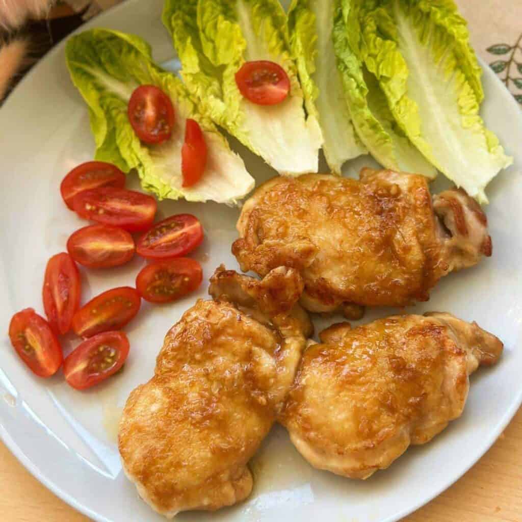 Close-up photo of mouthwatering teriyaki chicken, showcasing golden-brown glazed chicken pieces