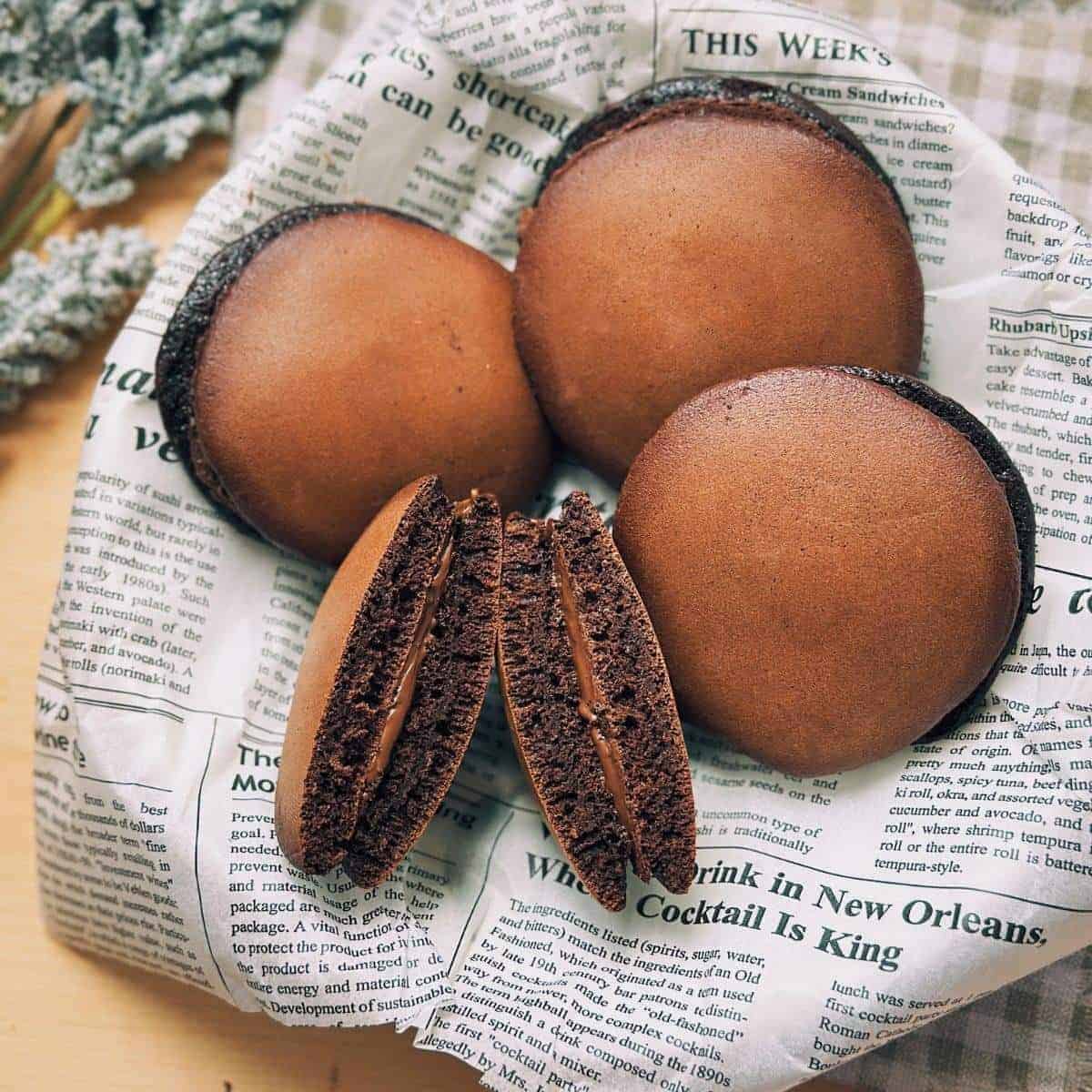 A close-up image of a delicious chocolate dorayaki dessert with a soft, golden pancake exterior and a luscious Nutella filling.