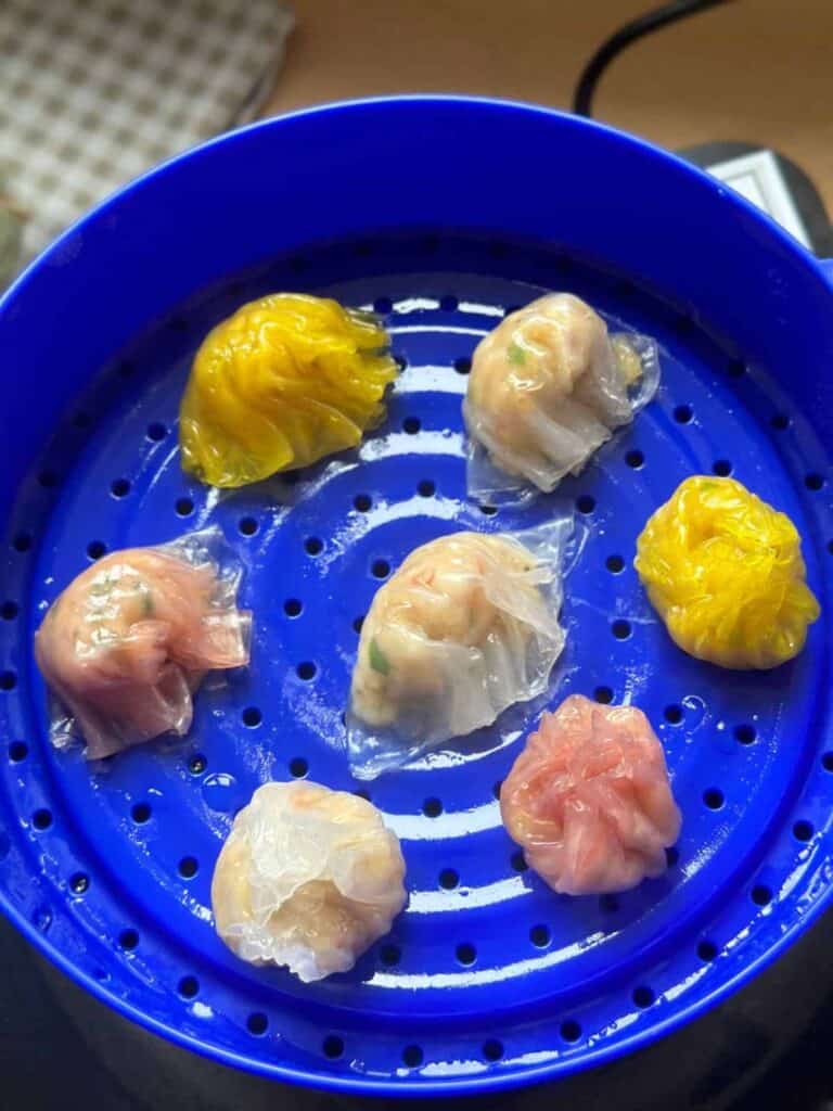 A close-up photo of Crystal Skin Dumplings, also known as Rice Paper Har Gow. The translucent rice paper wrappers delicately encase the savory fillings, creating a beautiful and mouthwatering dim sum dish.