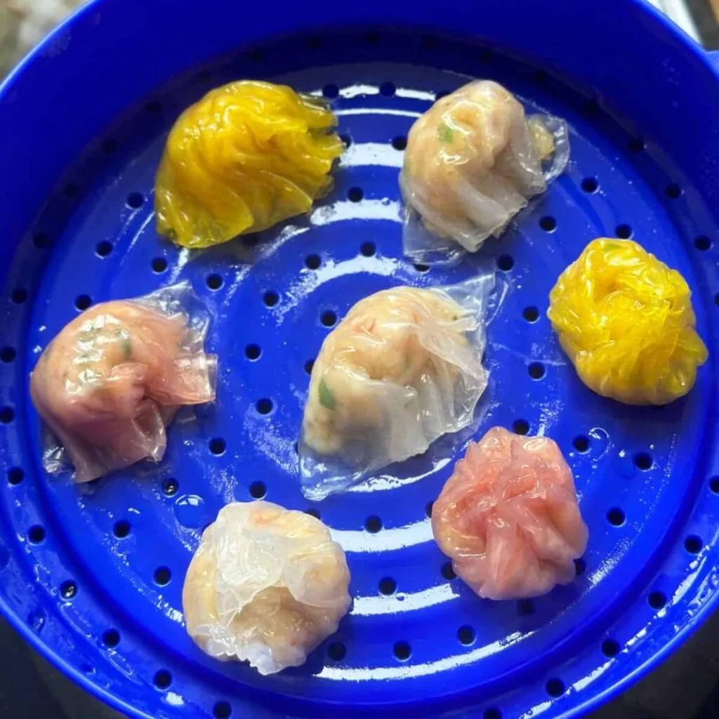 Vietnamese Spring Rolls with Peanut Sauce | Gỏi Cuốn A close-up photo of Crystal Skin Dumplings, also known as Rice Paper Har Gow. The translucent rice paper wrappers delicately encase the savory fillings, creating a beautiful and mouthwatering dim sum dish.