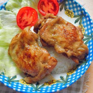 Vietnamese Sweet & Sour Pork Ribs (Sườn Xào Chua Ngọt) A plate of Com Ga Roti, featuring perfectly cooked chicken thighs glazed in a savory sauce, served with steamed rice. A delicious Vietnamese culinary delight."