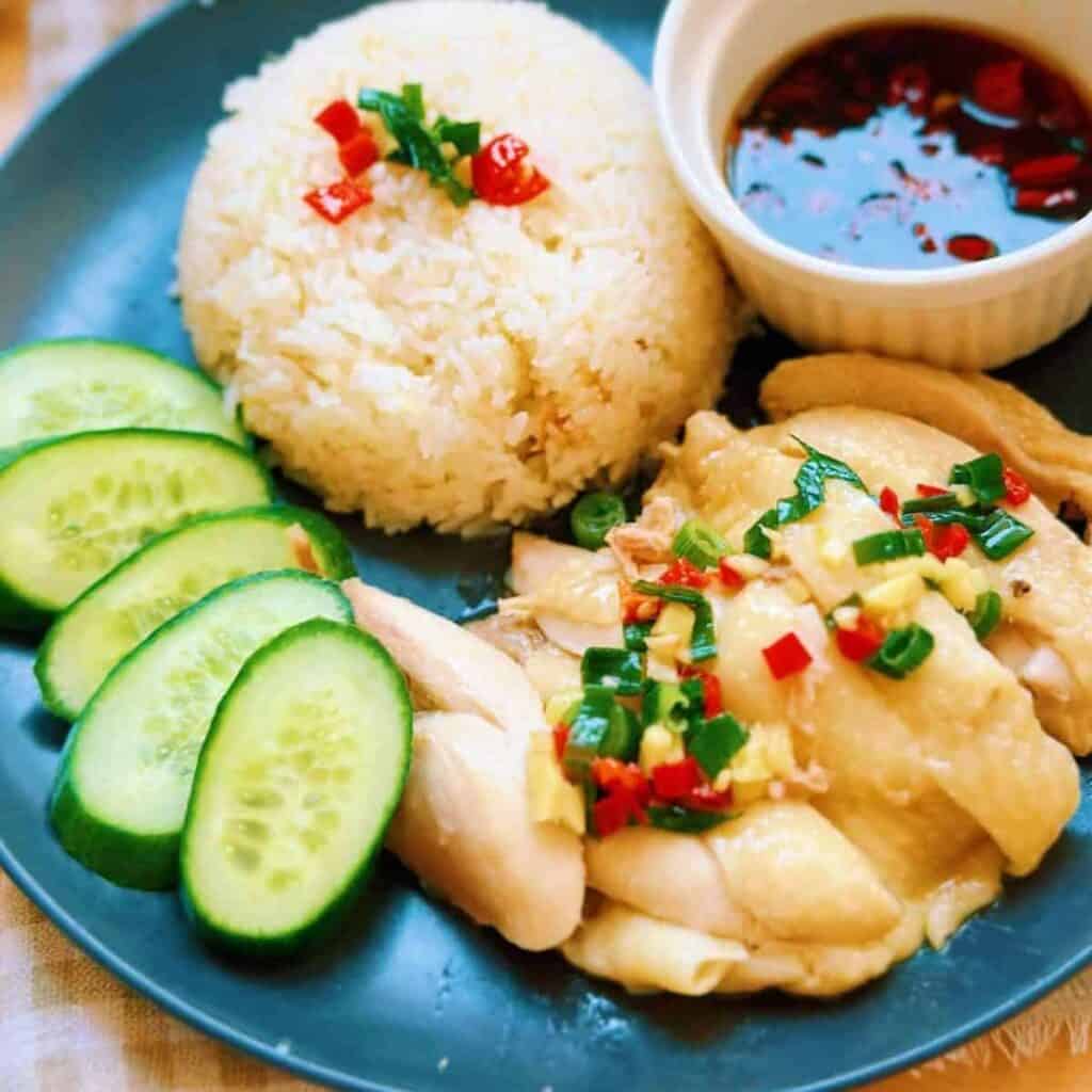 Delicious and aromatic Instant Pot Hainanese Chicken Rice, served with juicy chicken, fluffy rice, and delectable sauces.