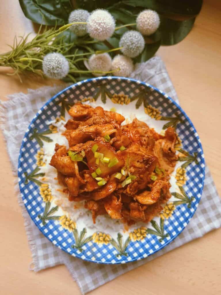 Korean Kimchi Duruchigi dish: A sizzling stir-fry of thinly sliced marinated pork, vibrant kimchi, and assorted vegetables.