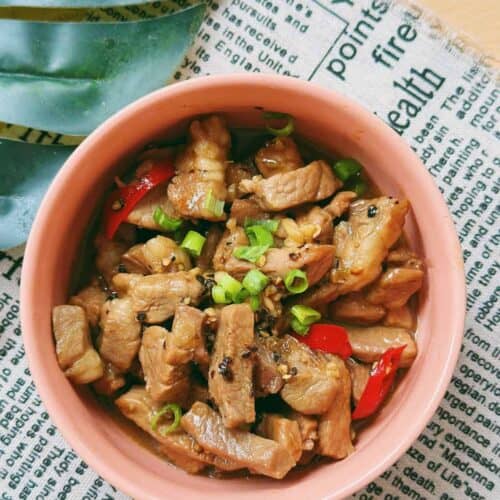 Thịt Kho Tiêu (Vietnamese Black Pepper Caramelized Pork) Delicious "thit kho tieu": Caramelized pork simmered in a rich sauce infused with black pepper and served with steamed rice. The tender and flavorful pork is garnished with scallions, creating a visually enticing and mouthwatering dish