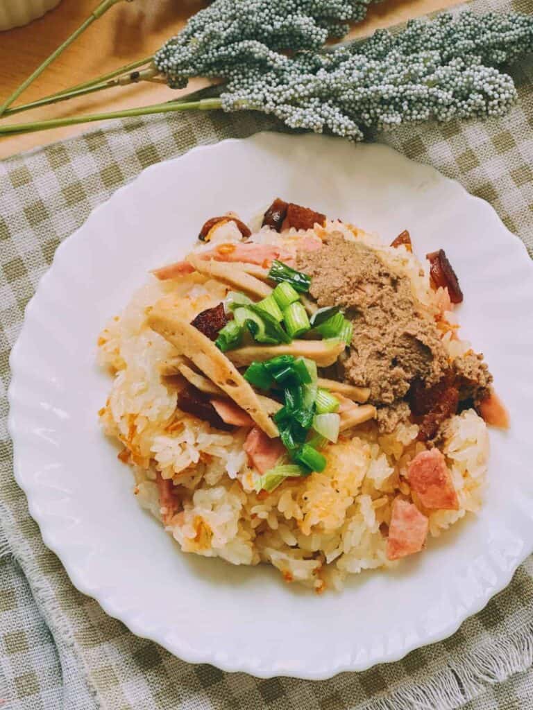 Delicious Vietnamese Xoi Man - A delectable plate of Vietnamese savory sticky rice adorned with flavorful toppings, a delightful treat from Vietnamese cuisine.