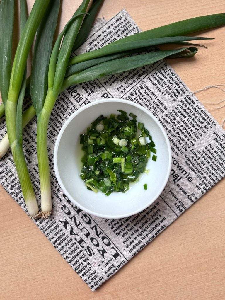 Mo Hanh, or Vietnamese scallion oil. The vibrant green oil is made by infusing scallions in vegetable oil or pork lard, resulting in a flavorful and aromatic condiment.