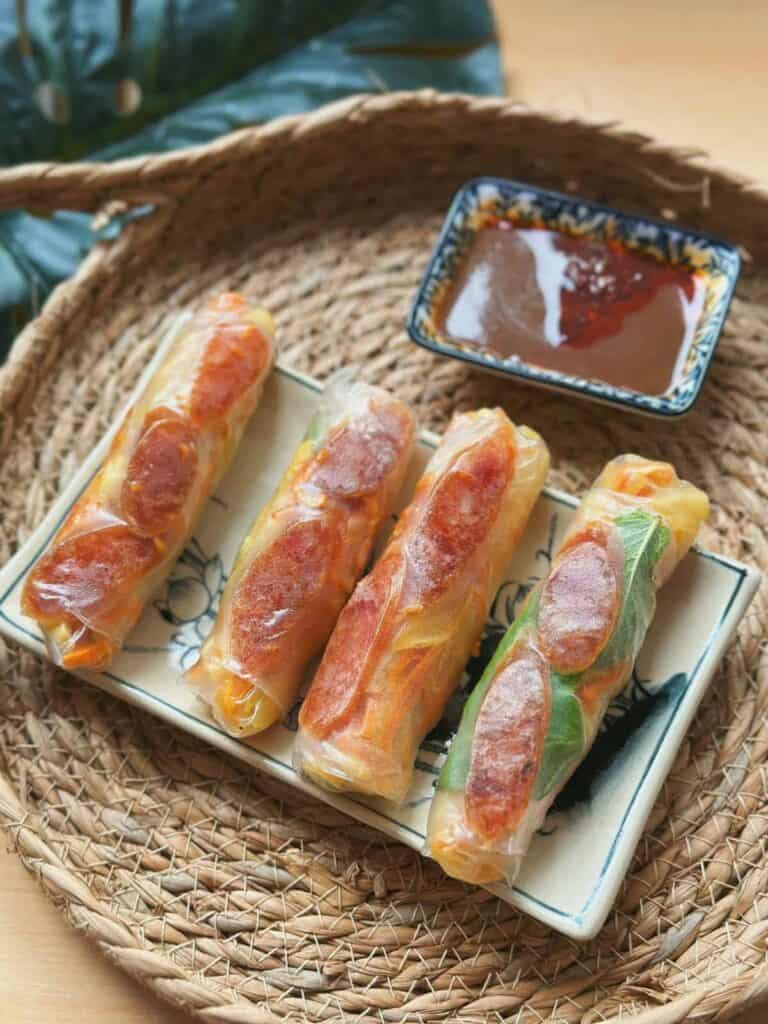 Delicious Vietnamese Bo Bia Spring Rolls: Rice paper rolls filled with Chinese sausages, jicama, and carrots - a perfect blend of flavors and textures.