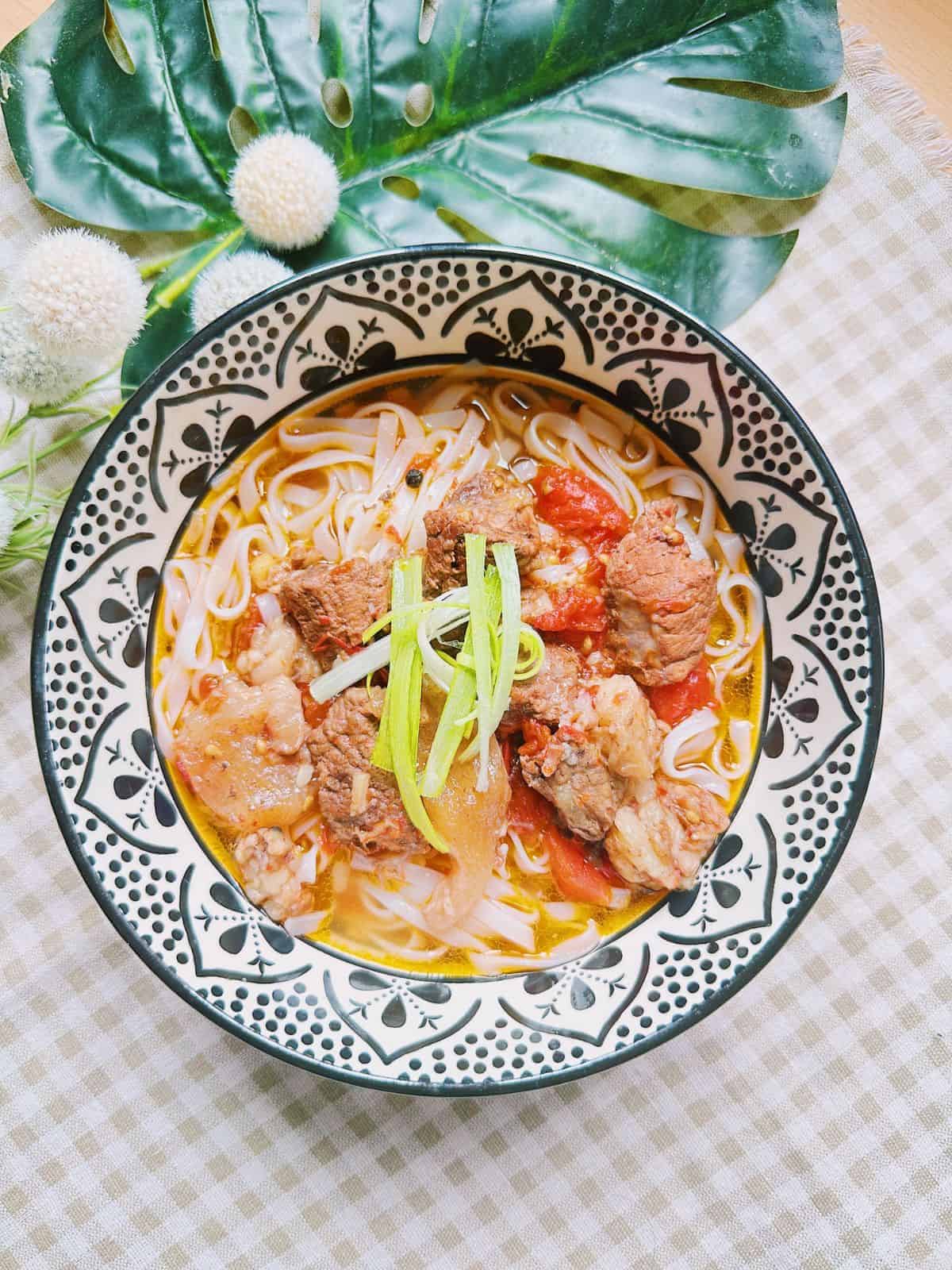 A bowl of Pho Bo Sot Vang, Vietnamese beef stew infused with red wine and aromatic spices.