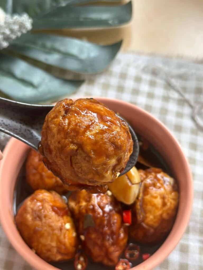 a bowl of Chinese Tiger Eggs (Chinese Tiger Skin Eggs), showcasing marbled patterns on hard-boiled eggs coated in a flavorful sauce, ready to be enjoyed.