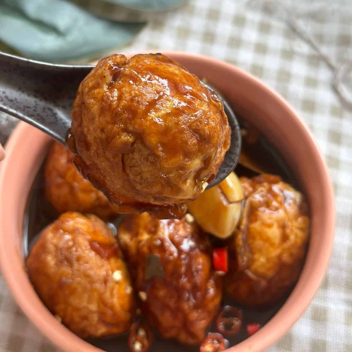 a bowl of Chinese Tiger Eggs (Chinese Tiger Skin Eggs), showcasing marbled patterns on hard-boiled eggs coated in a flavorful sauce, ready to be enjoyed.