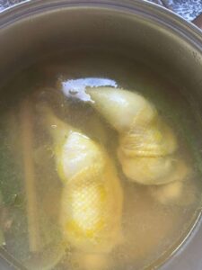 poached chicken in the fragrant liquid
