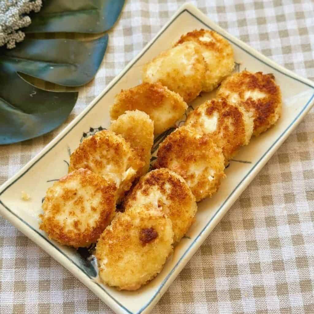 Golden and crispy fried silken tofu cubes with a tender, melt-in-your-mouth interior.
