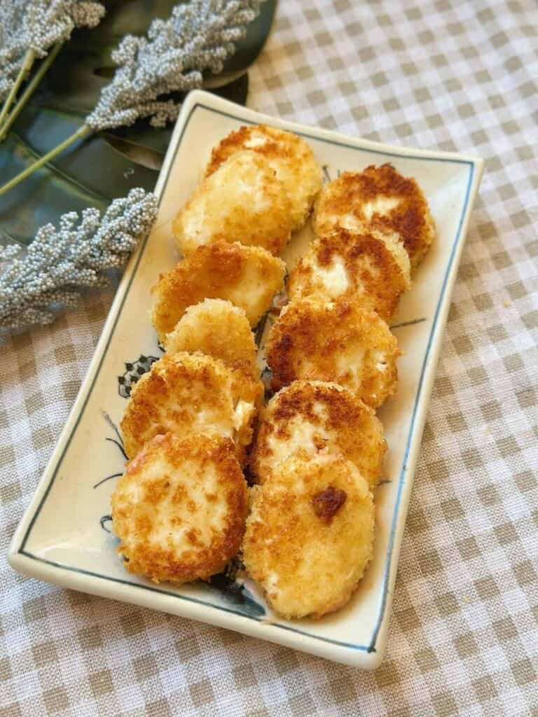 Golden and crispy fried silken tofu cubes with a tender, melt-in-your-mouth interior.