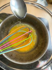 Gradually pour oil while whisking the egg yolk.
