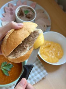 Spread mayo on both sides of the roll.