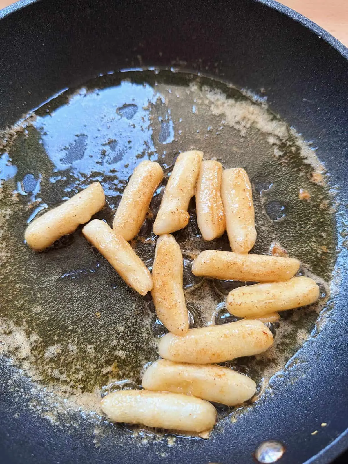 Easy Honey Butter Tteokbokki (Non Spicy) fry korean rice cakes in a pan