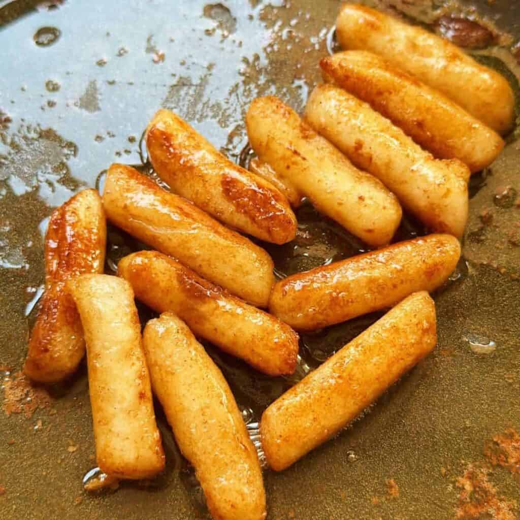 Honey Butter tteokbokki in a pan with delicious buttery glaze.
