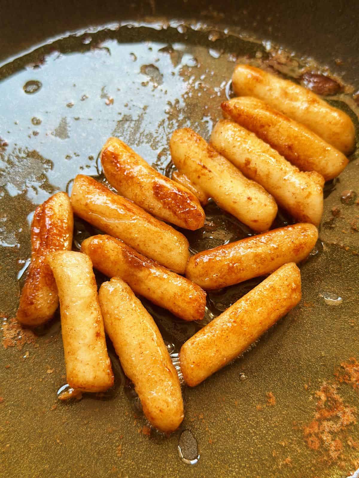 Easy Honey Butter Tteokbokki (Non Spicy) Honey Butter tteokbokki in a pan with delicious buttery glaze.