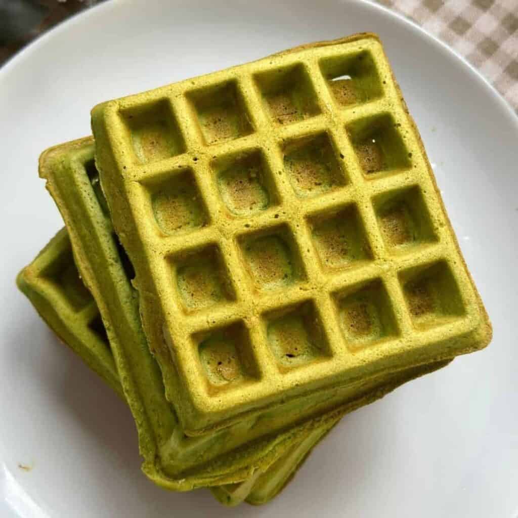Freshly made matcha waffles with a golden crispy exterior and a soft green tea-infused interior.