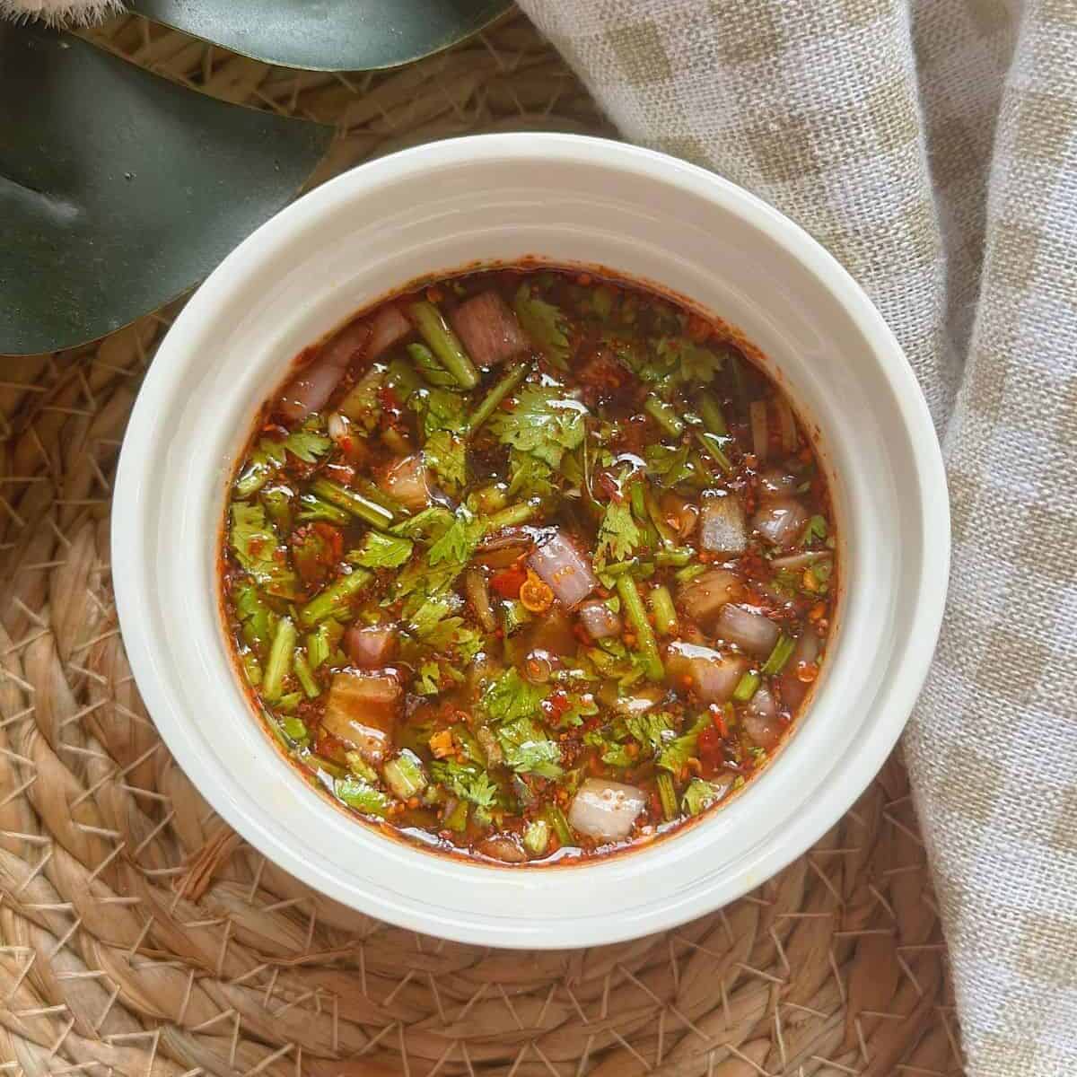 Nam Jim Jaew, a delectable Thai dipping sauce, in a small bowl.