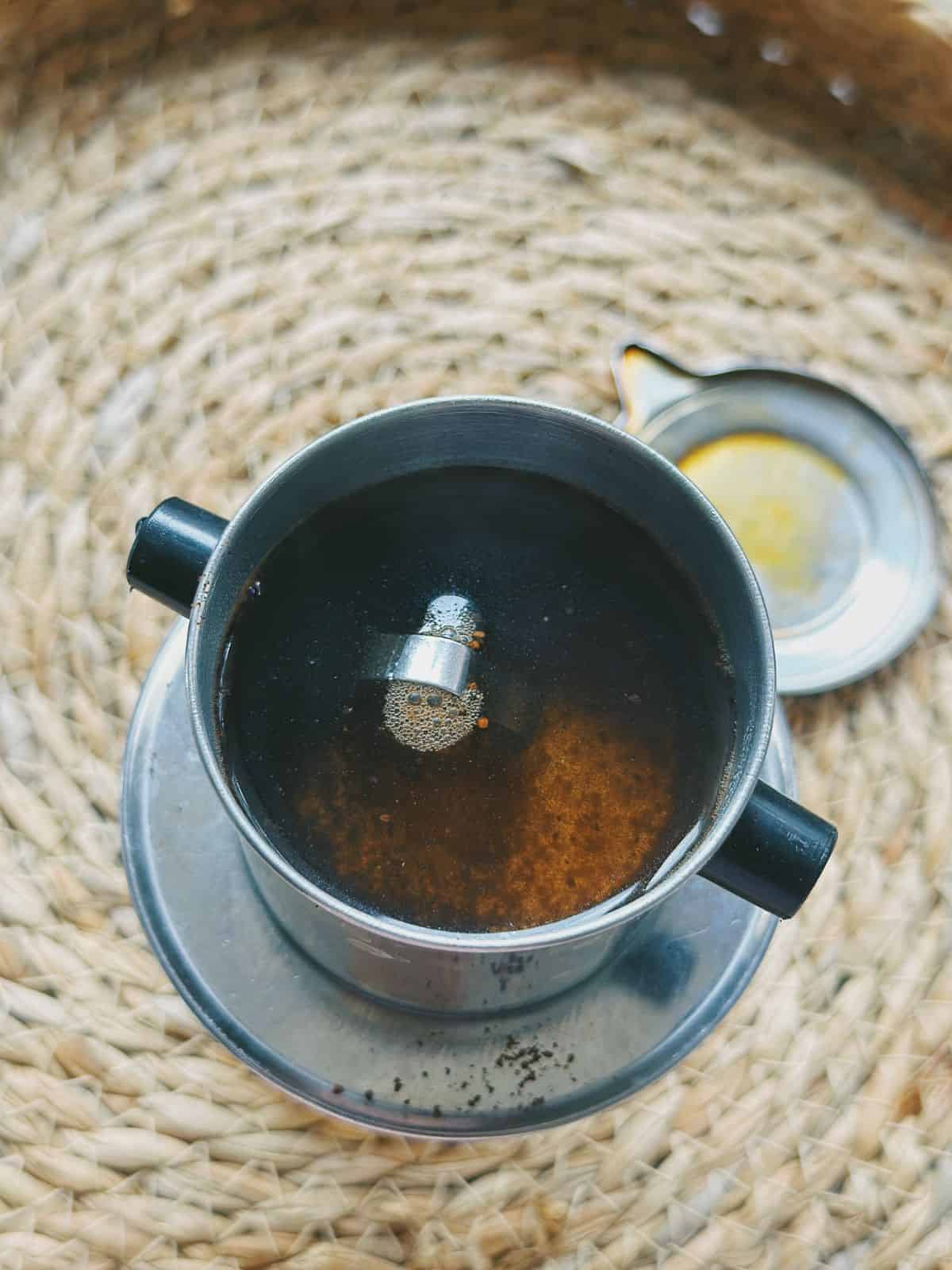 Drip Vietnamese coffee with a phin filter.