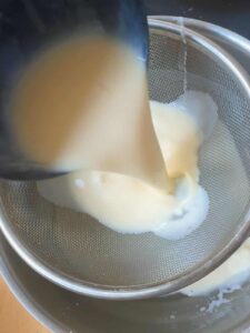 Sieve the flan mixture through a strainer.