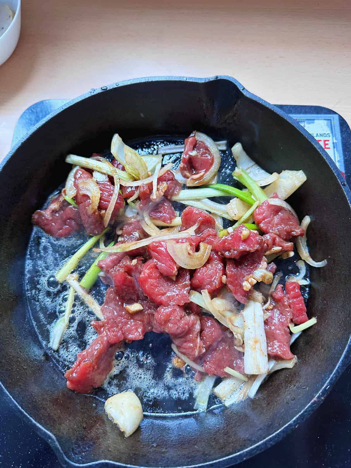 Stir-fry the beef with a cast iron pan.