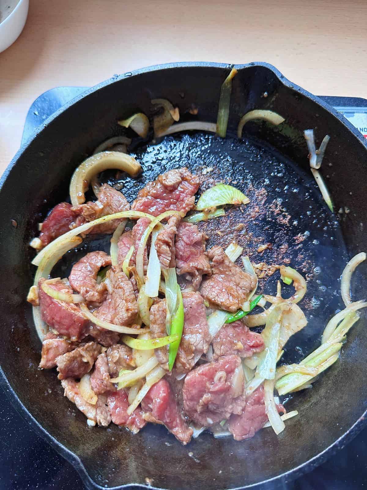 Stir-fry the beef with a cast iron pan.
