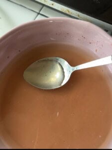 Season the broth using only the clear liquid from the top of the shrimp paste solution, leaving the sediment behind.