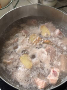 Parboil the pork ribs.