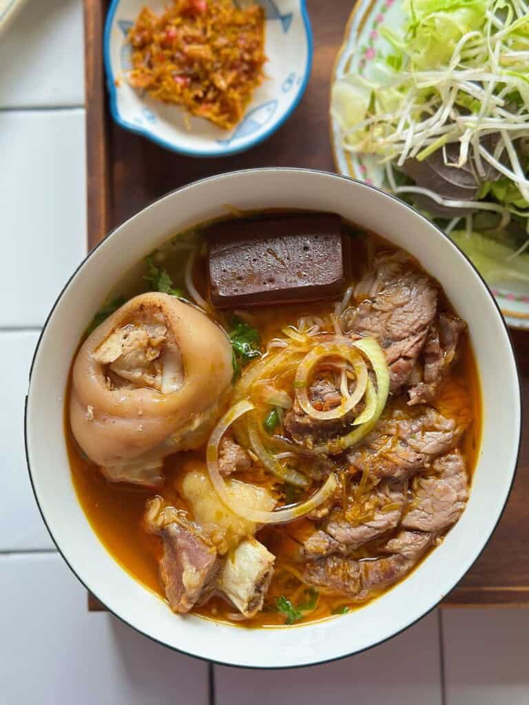a bowl of Bún Bò Huế (Vietnamese spicy beef noodle soup)