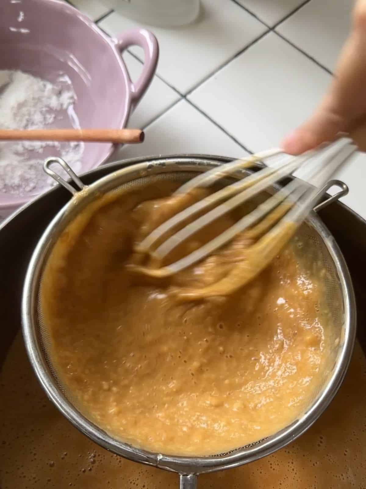 Vietnamese Palm Sugar Honeycomb Cake (Bánh Bò Thốt Nốt) Strain the batter through a sieve to ensure a smooth consistency.