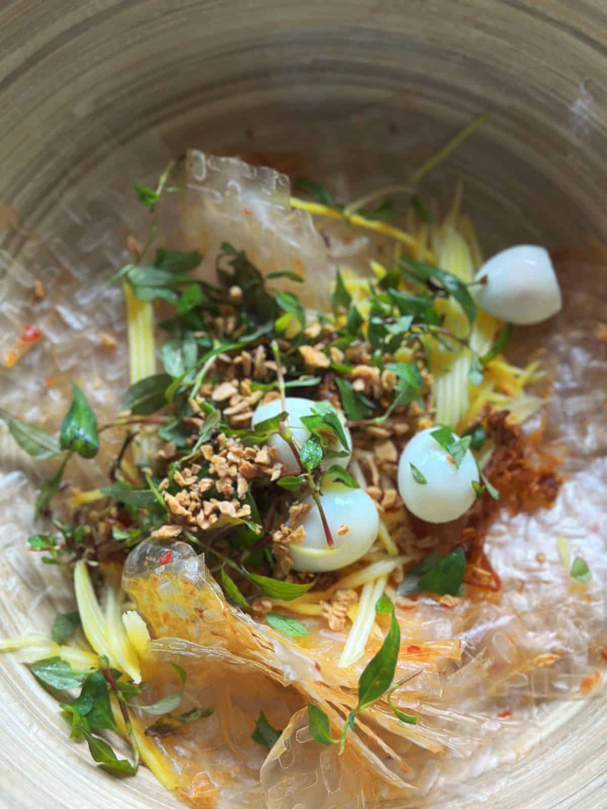 Easy Bánh Tráng Trộn (Vietnamese Rice Paper Salad) Mix rice papers with Vietnamese corianders, green mango, fried garlic and quail eggs.