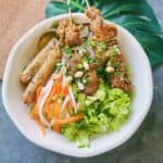 Bowl of Bún Thịt Nướng Chả Giò alongside Nước Chấm with pickled carrots and daikon.