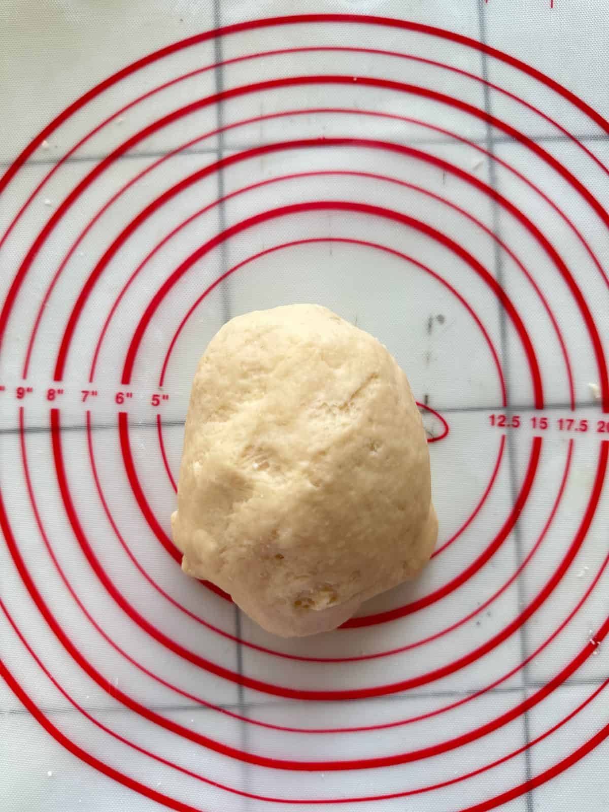 A ball of dough on a silicone pastry mat.