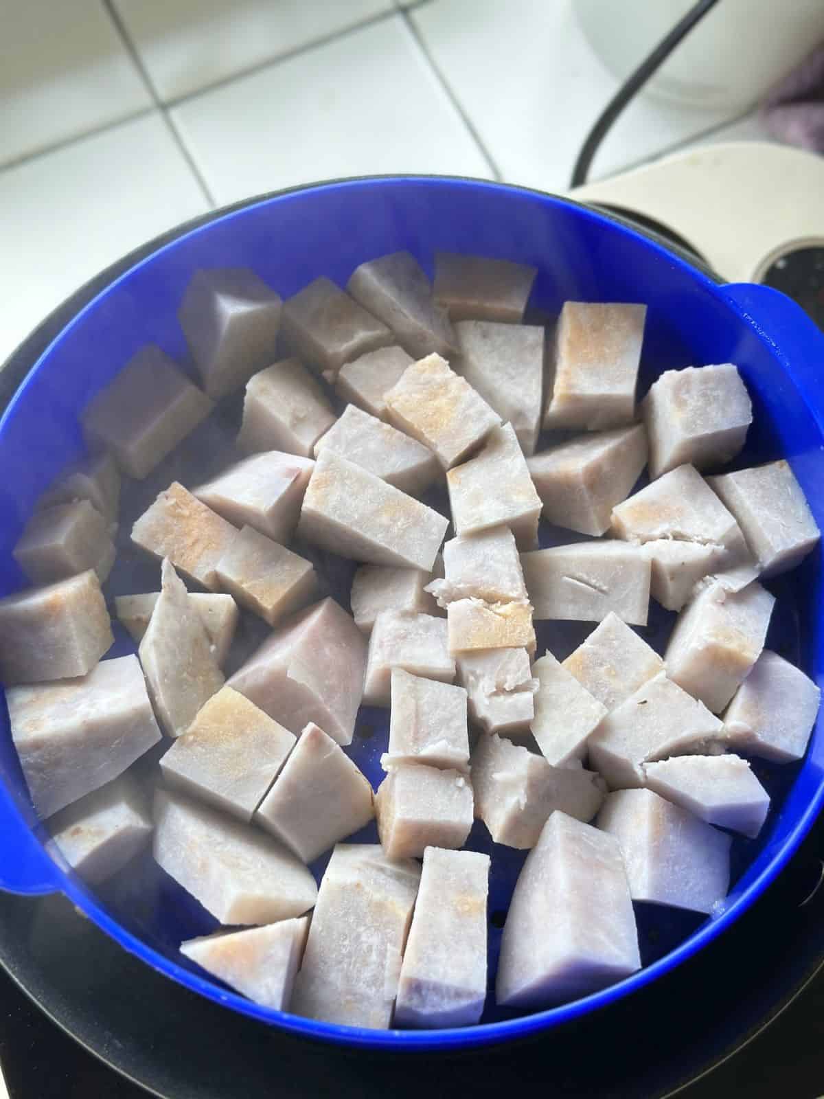 Steamed taro chunks in a steamer.