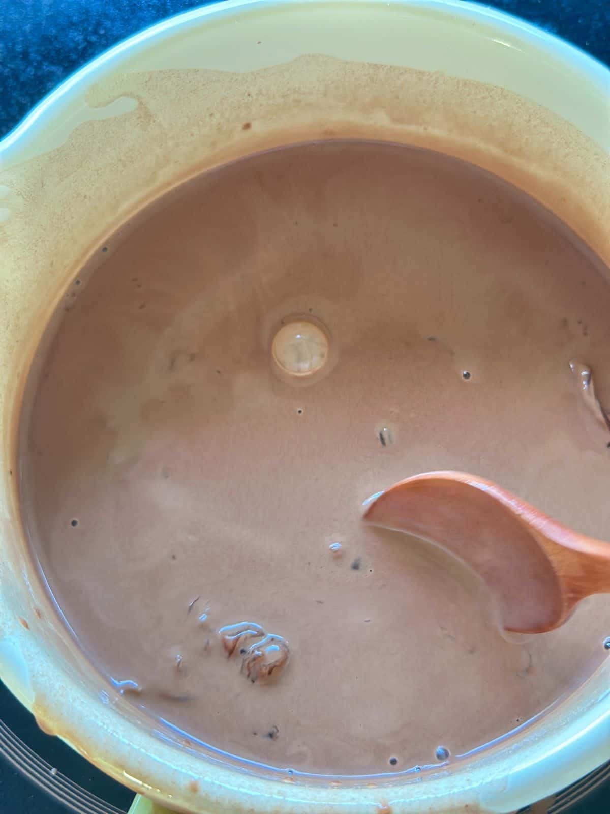 Tapioca starch mixture being stirred in a saucepan before thickening.