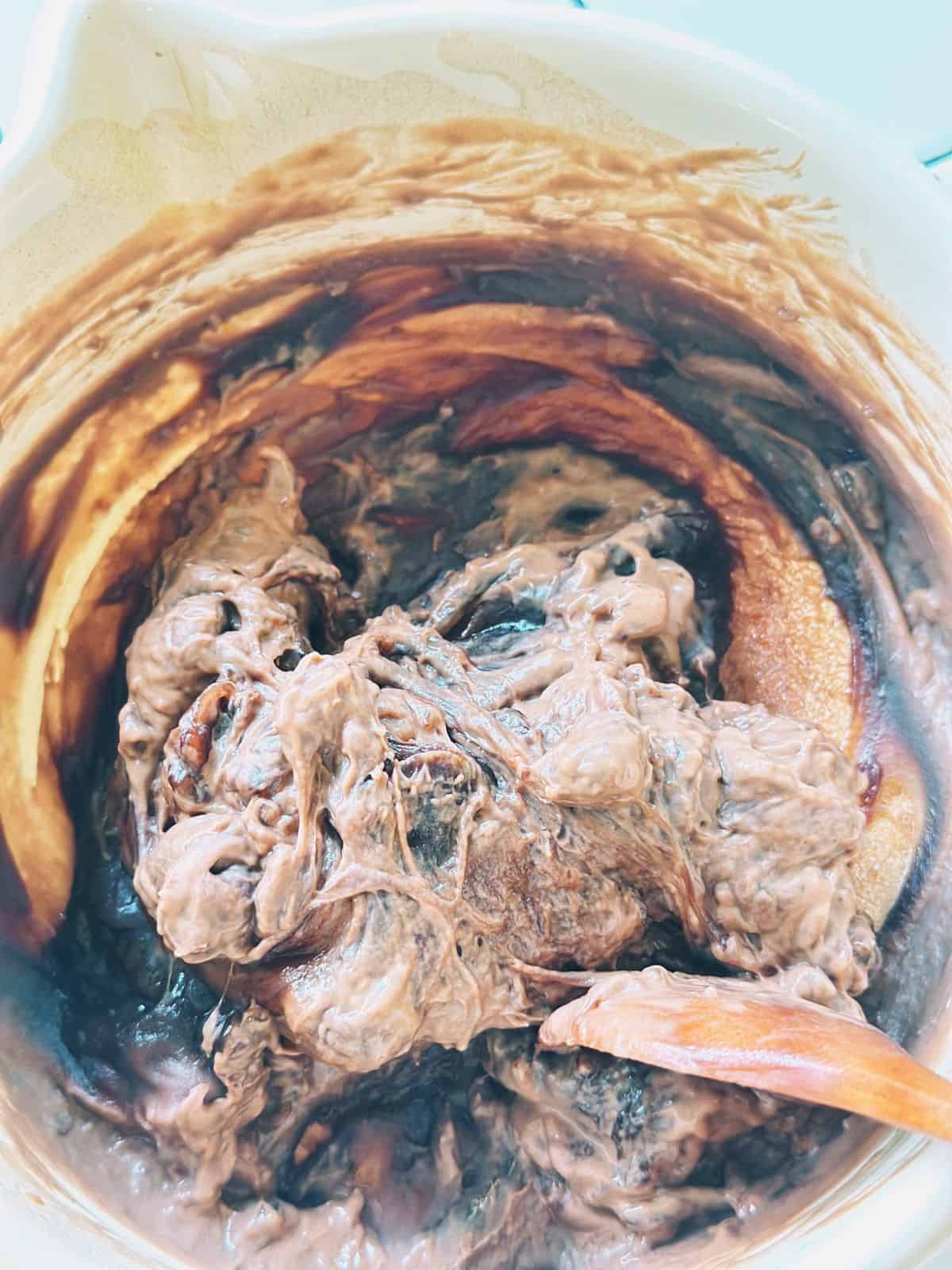 Thick, sticky tapioca dough in a saucepan, resembling mochi after cooking.