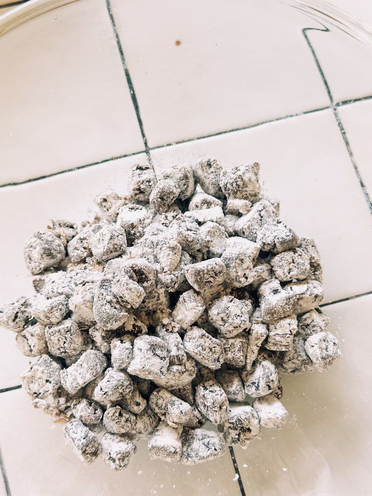 Uncooked brown boba pearls coated with tapioca starch, slightly rustic and ready for boiling.