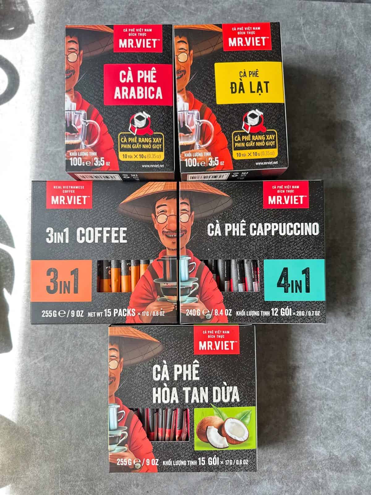 Assorted Mr Viet coffee boxes with bright red packaging featuring the smiling man in a nón lá.