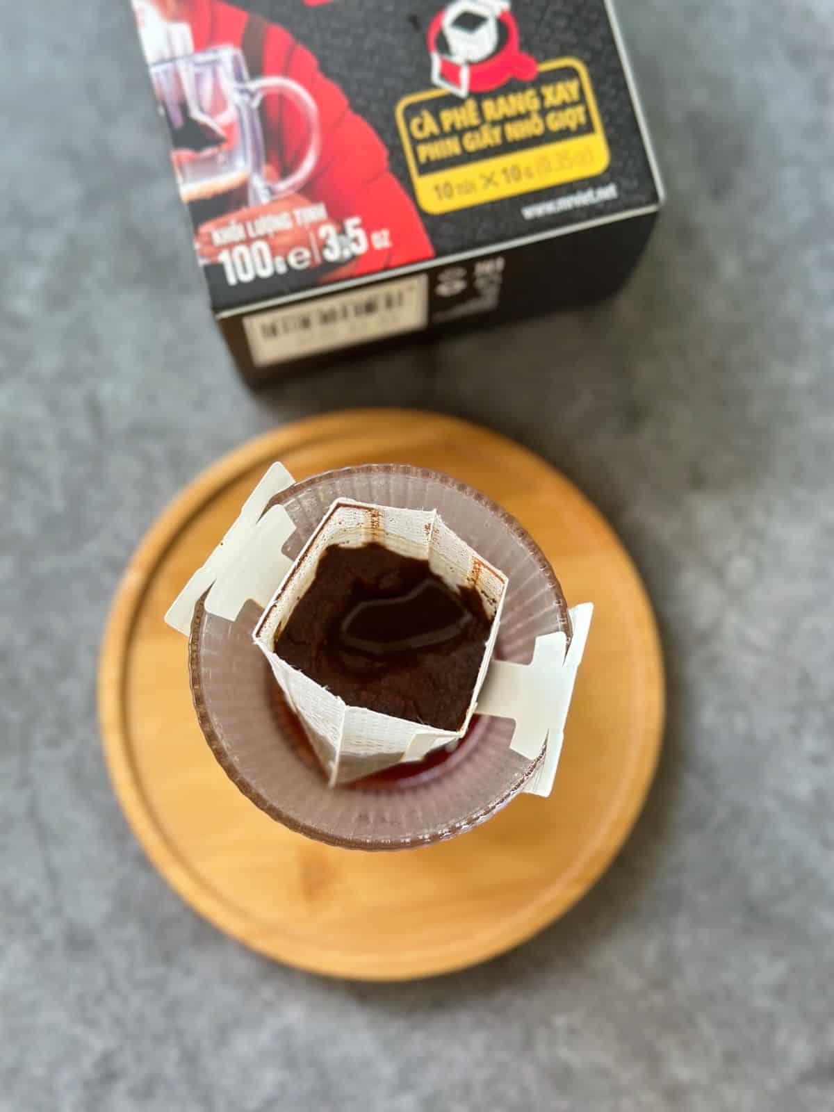 Mr Viet paper drip coffee brewing directly into a glass cup.
