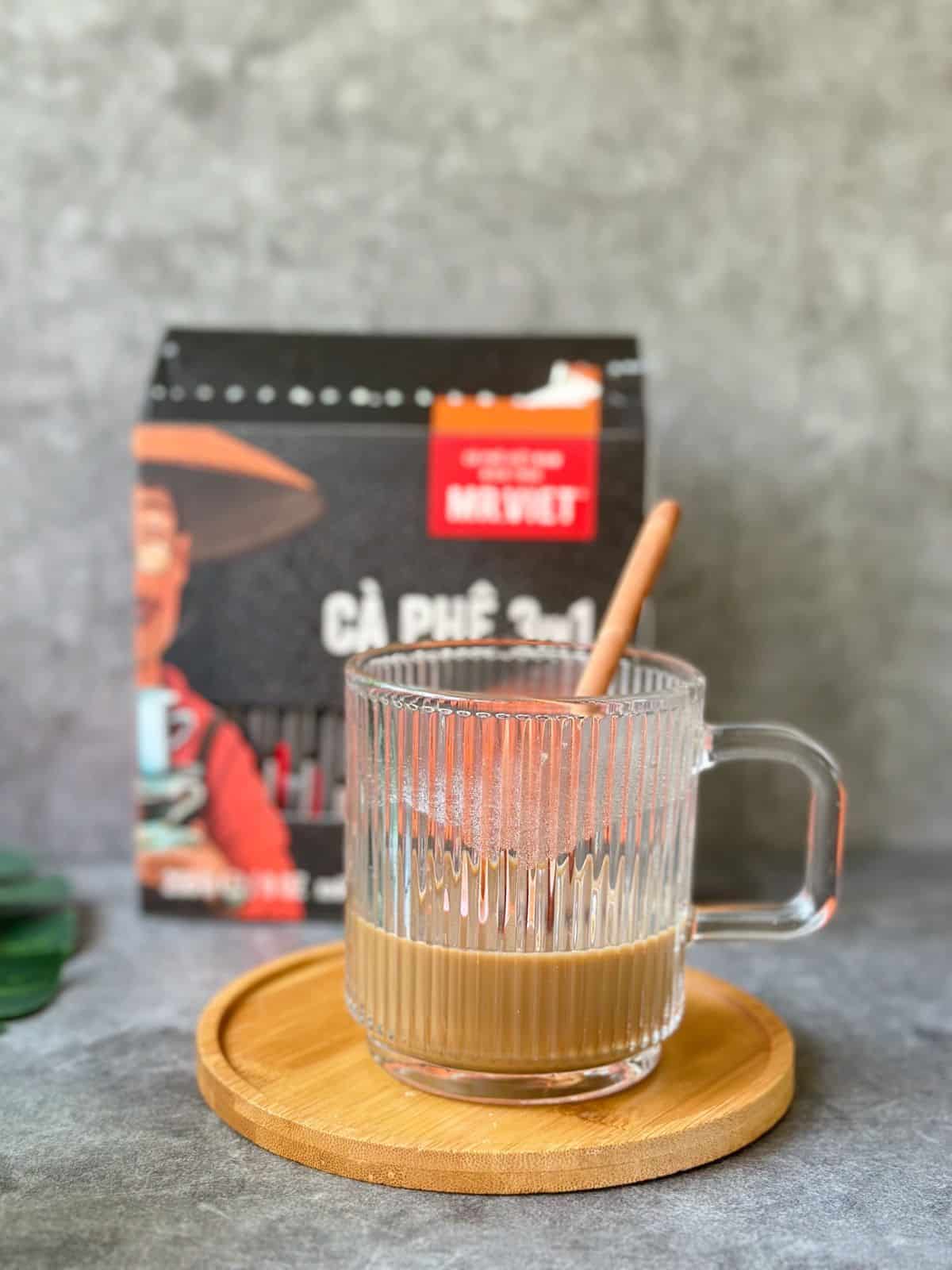 A glass cup filled with prepared Mr Viet instant coffee.