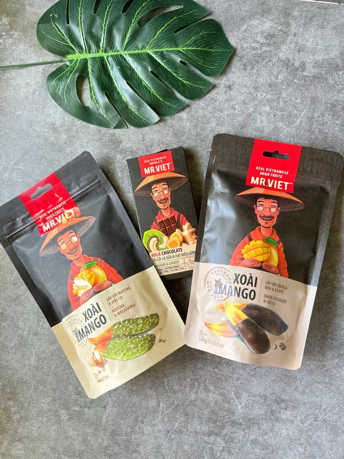 Packs of Mr Viet dried mango fruit snacks in colorful packaging.