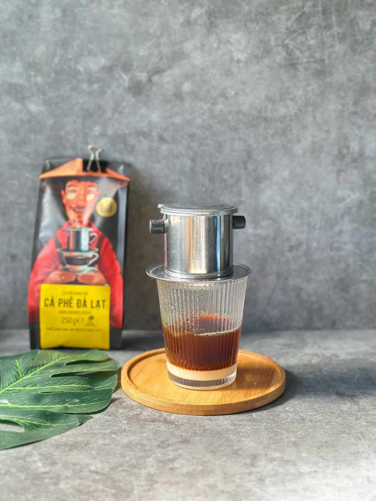 Traditional Vietnamese coffee slowly dripping through a phin filter.
