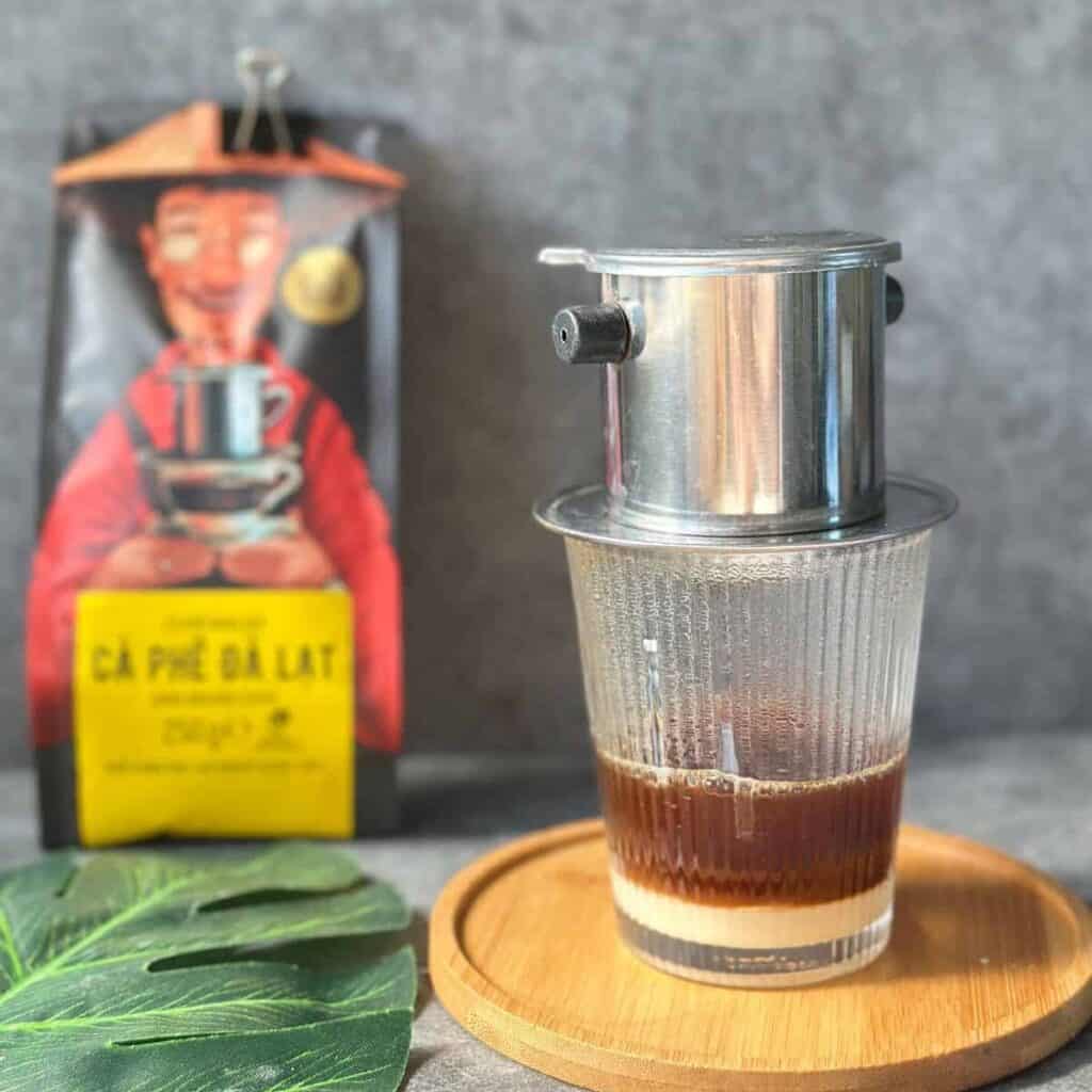 Traditional Vietnamese coffee slowly dripping through a phin filter.