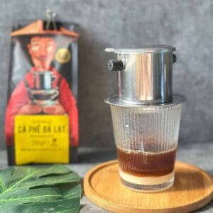 Traditional Vietnamese coffee slowly dripping through a phin filter.