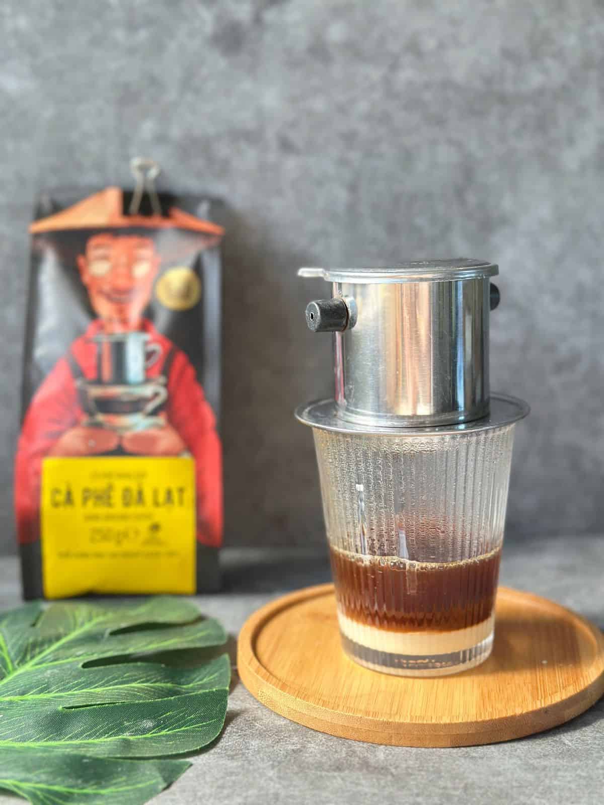 Traditional Vietnamese coffee slowly dripping through a phin filter.